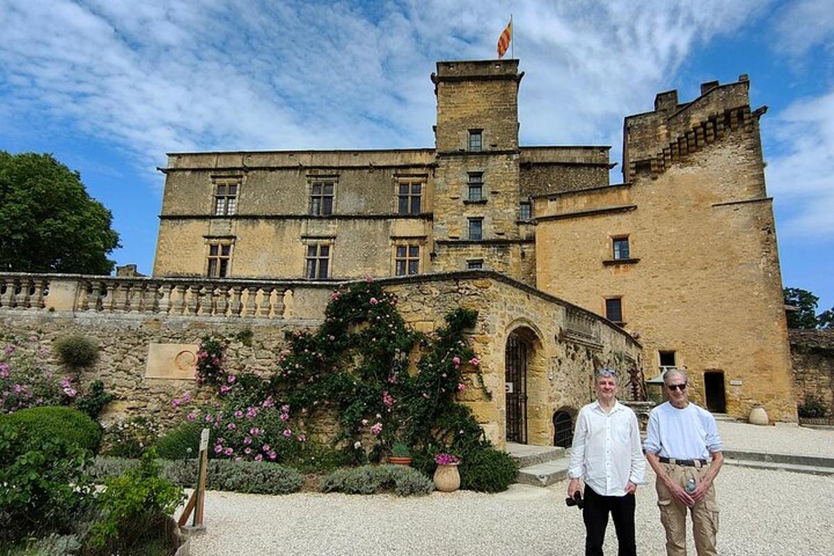 a man and a woman standing in front of a castle