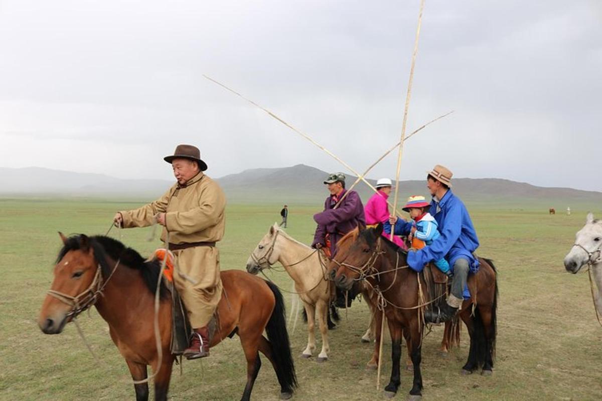 a group of people riding horses in a field