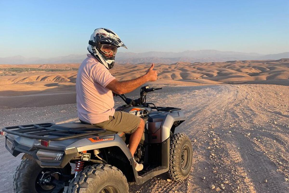 a man on a quad bike in the desert