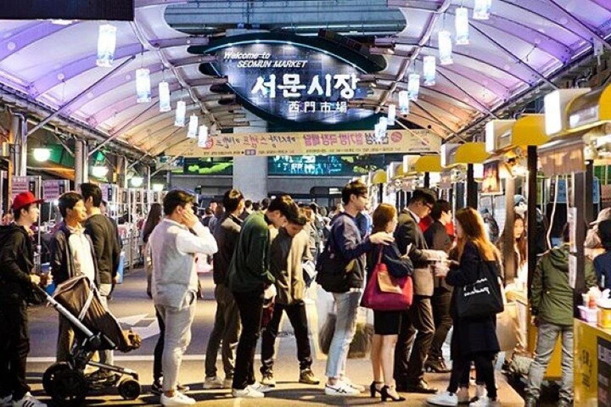 a group of people standing in a subway station