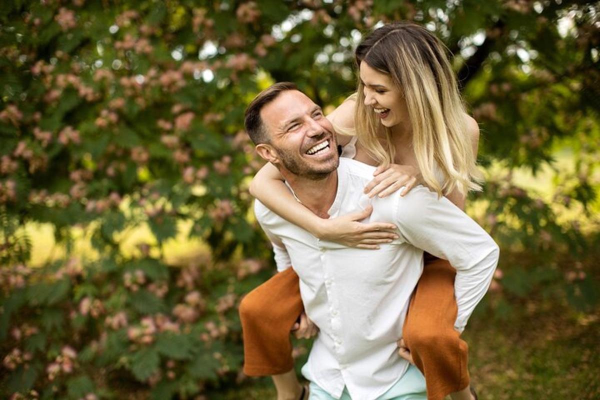 a man carrying a woman on his back