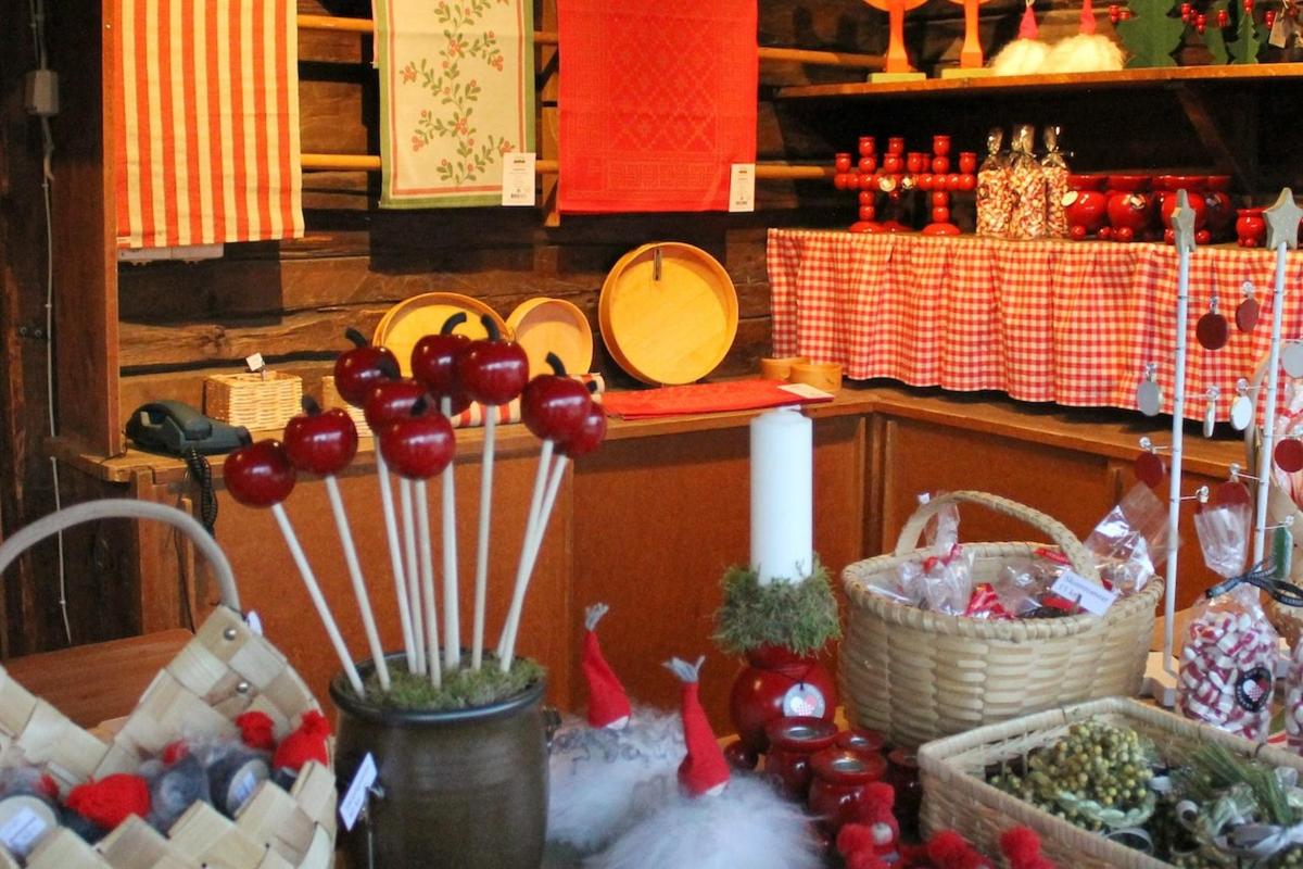 a kitchen with a table with baskets of fruit and vegetables