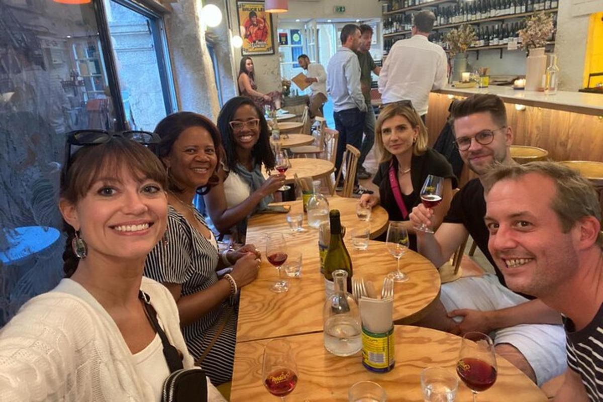 a group of people sitting around a table in a restaurant