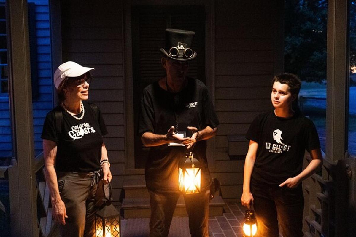 a group of people standing on a porch with lights