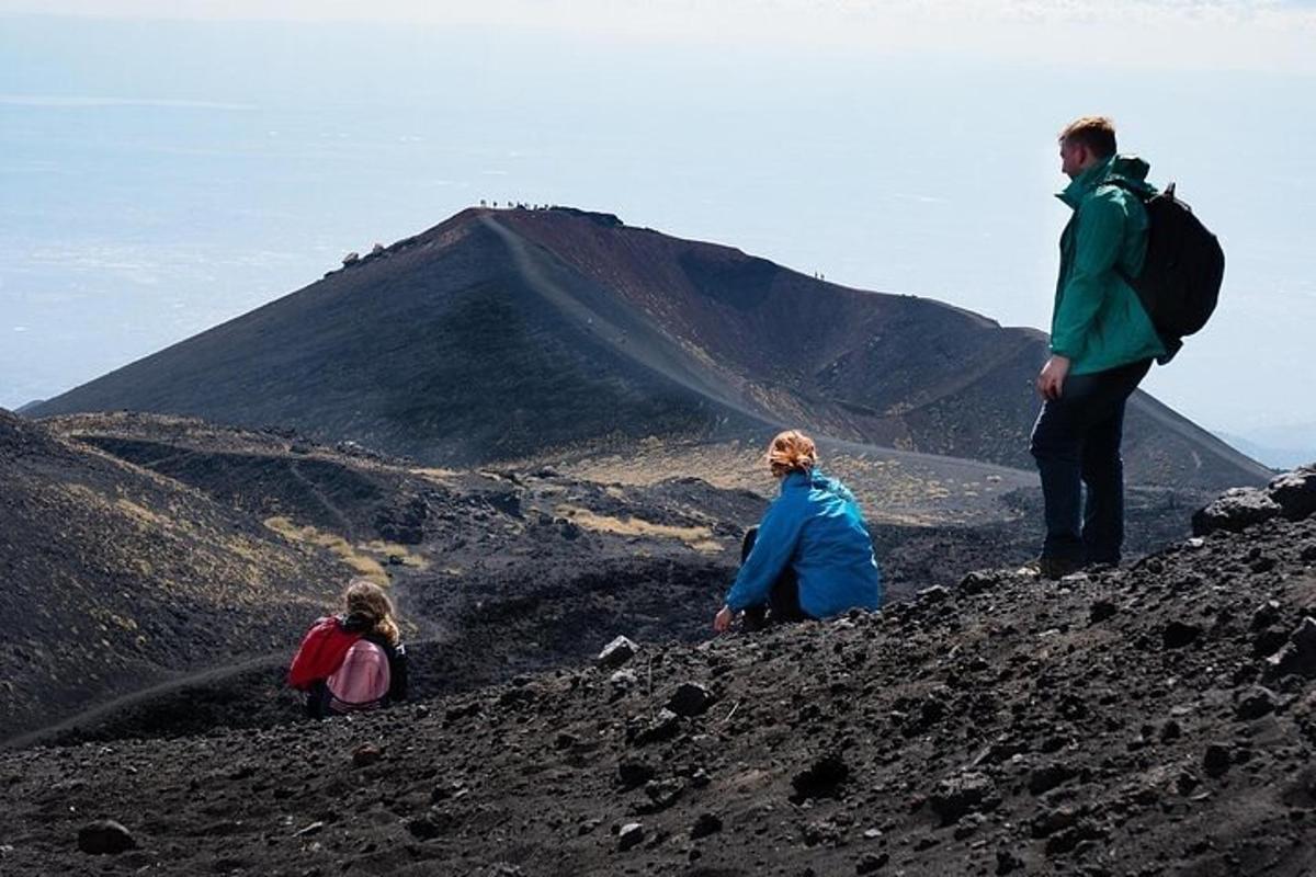a group of people sitting on top of a mountain