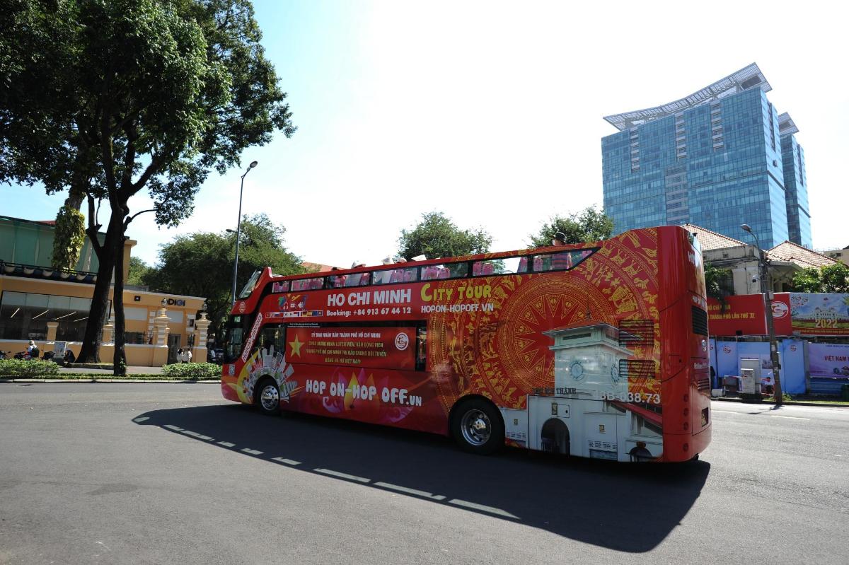 a red double decker bus driving down a street