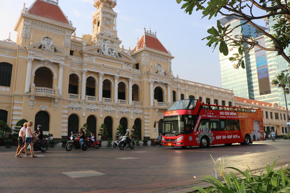 a red double decker bus in front of a building