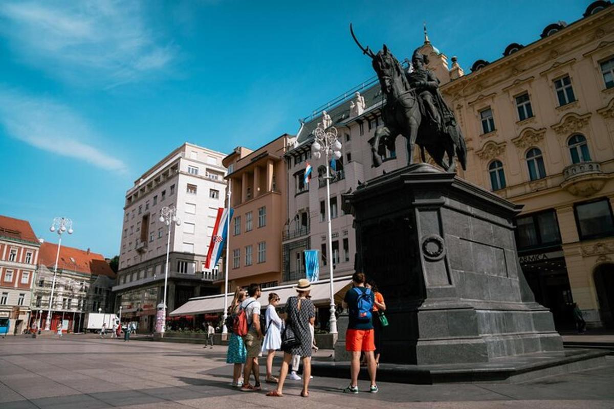 a group of people standing in front of a statue