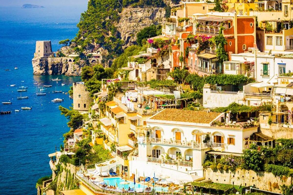 a group of houses on a hill next to the ocean