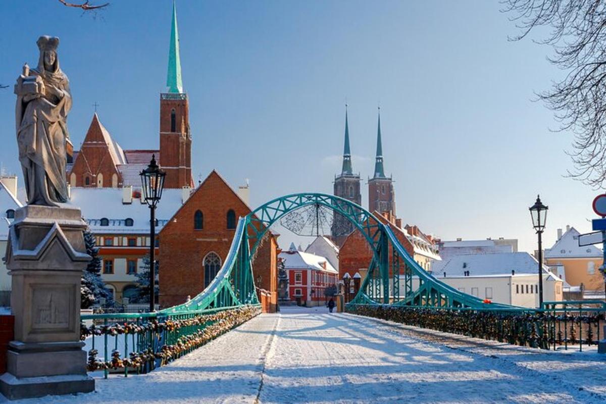a green bridge over a city with a statue