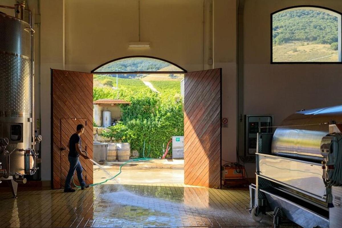 a man standing in a room with a hose
