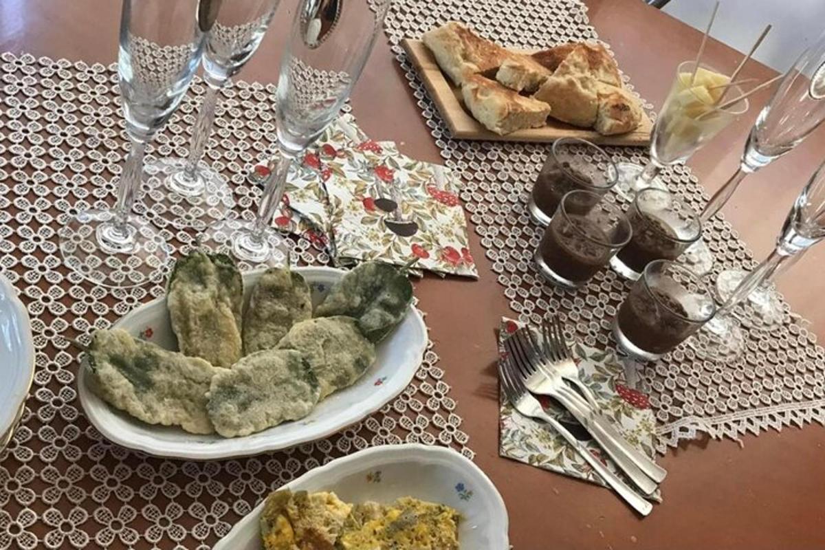 Una mesa con un plato de comida y copas de vino.