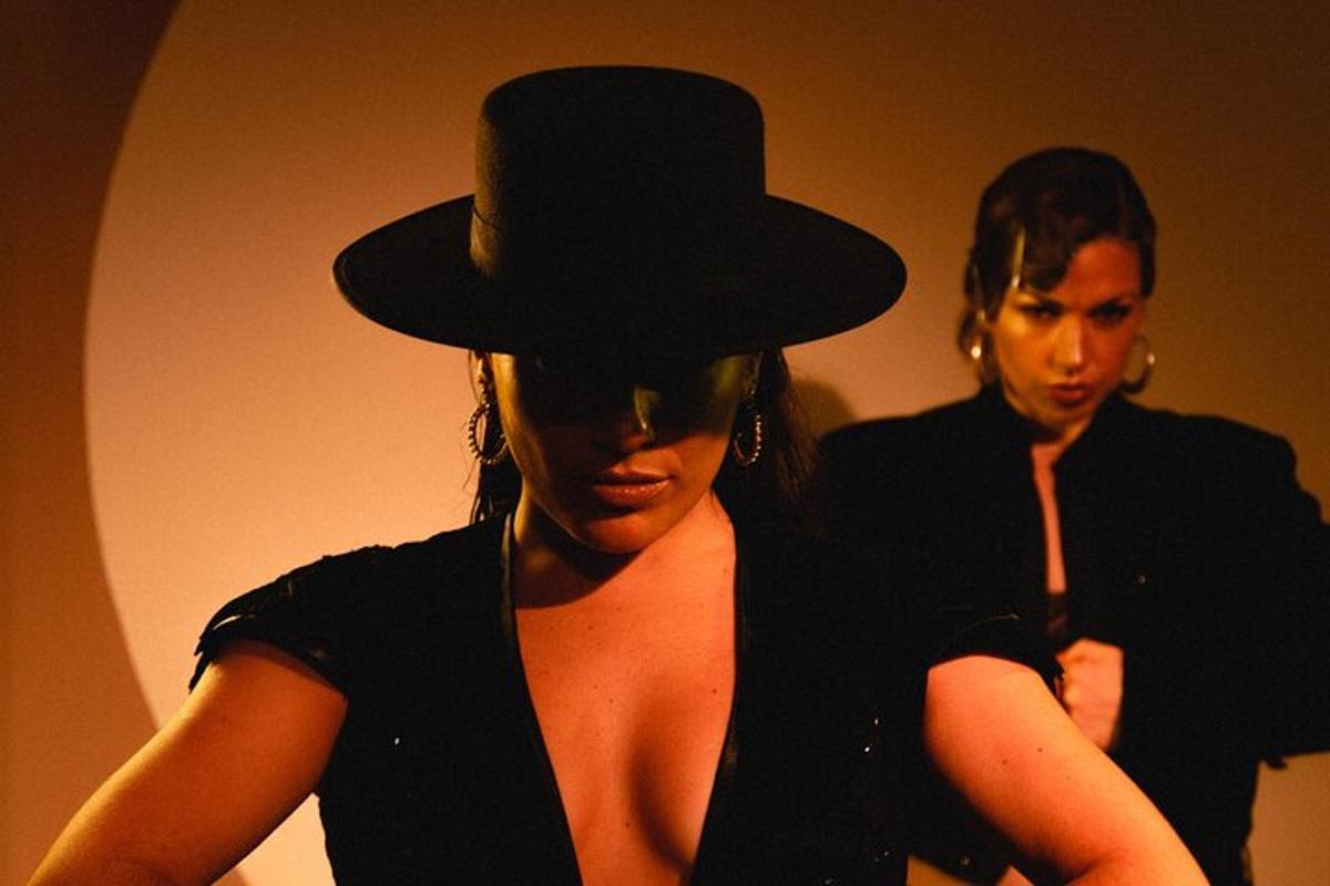 a woman wearing a black hat standing next to a man