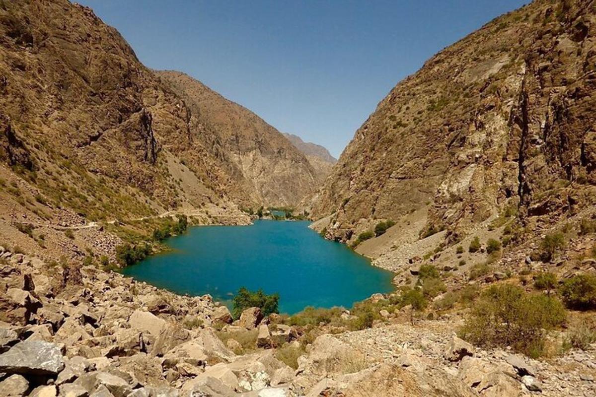 a view of a blue lake in a mountain valley