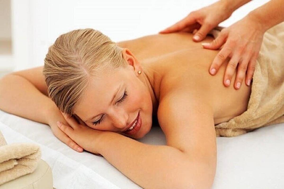 a woman laying on a bed in a towel