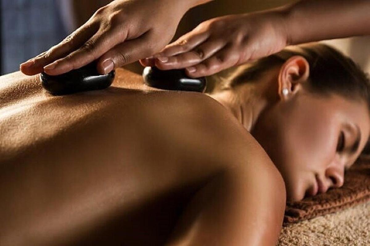 a woman getting her hair cut by a massage therapist