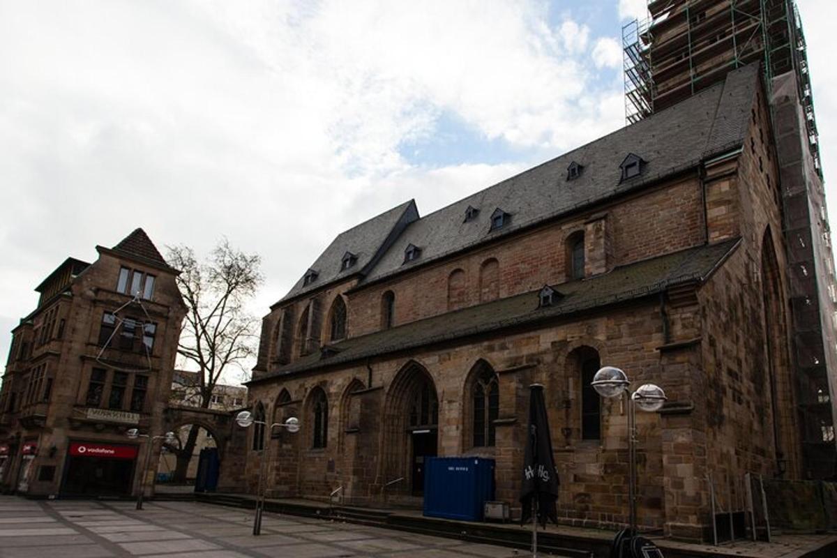 an old brick building with a clock tower on a street