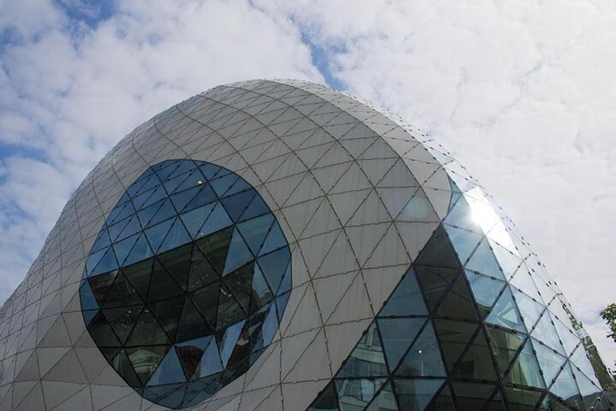 a large curved building with a glass dome