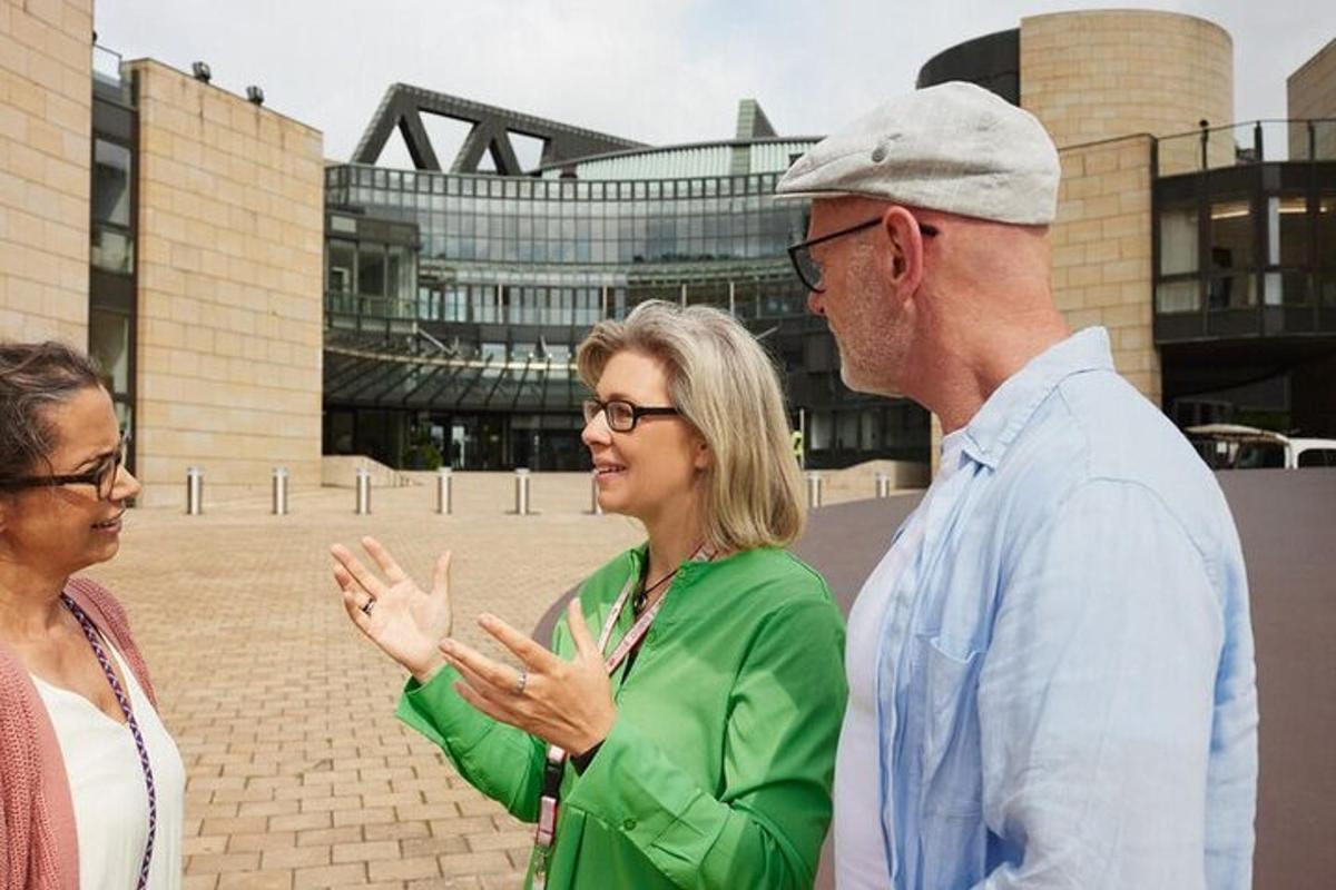 a man and two women standing in front of a building