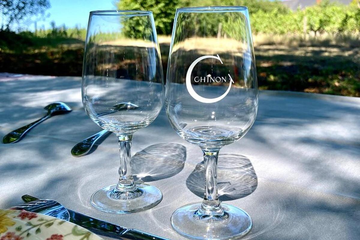two wine glasses sitting on top of a table