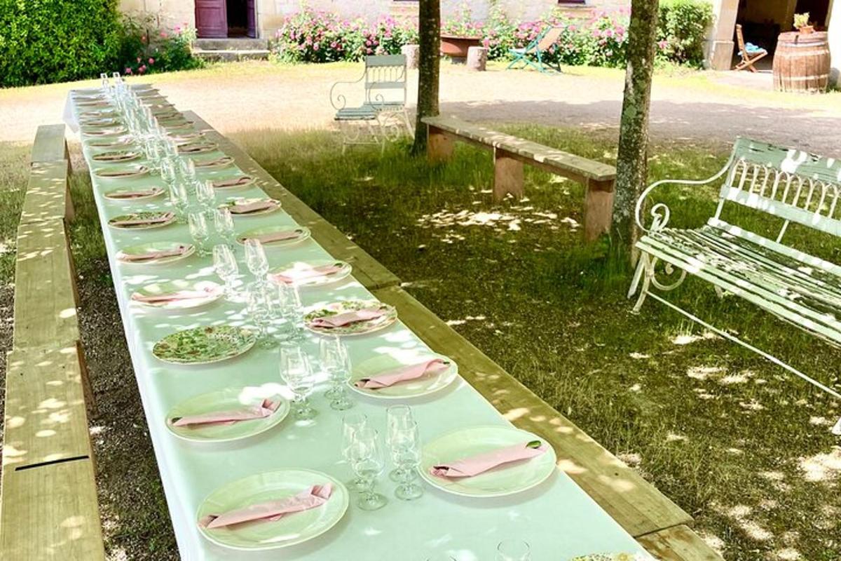 a long table with glasses and plates and a bench