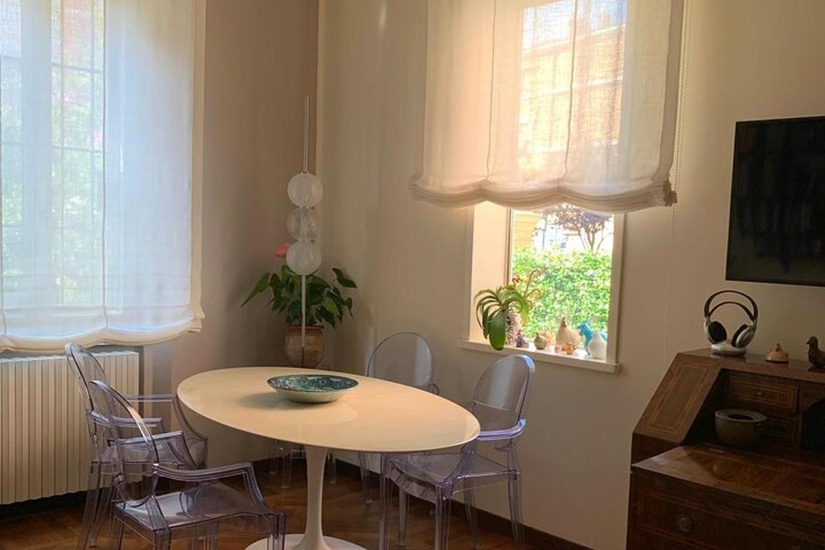 a dining room with a table and chairs and a window