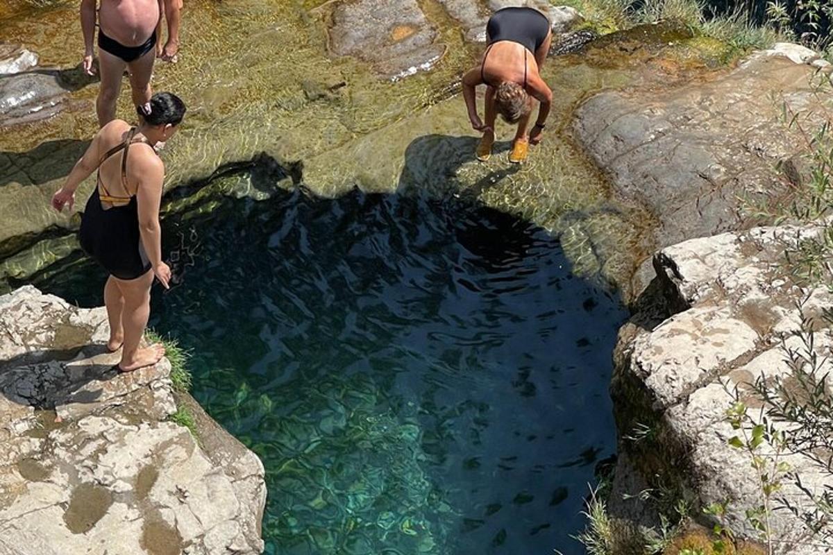 a group of people standing around a pool of water