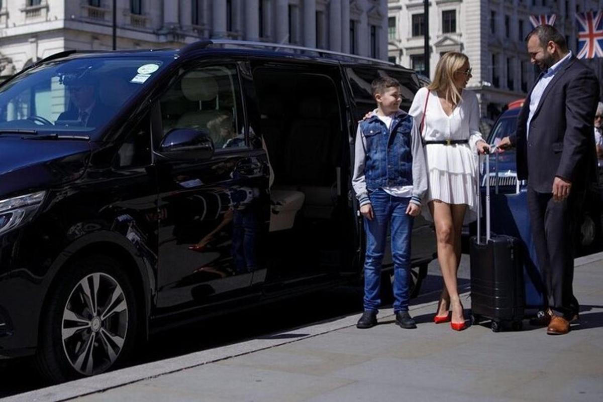a woman and a man standing in front of a van