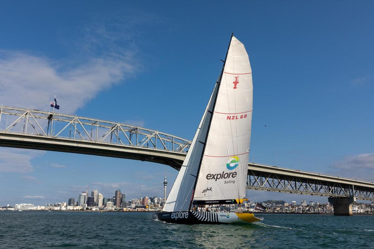 a sailboat in the water next to a bridge