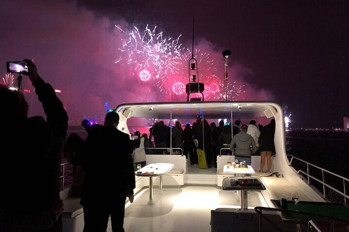 a group of people standing on a boat with fireworks
