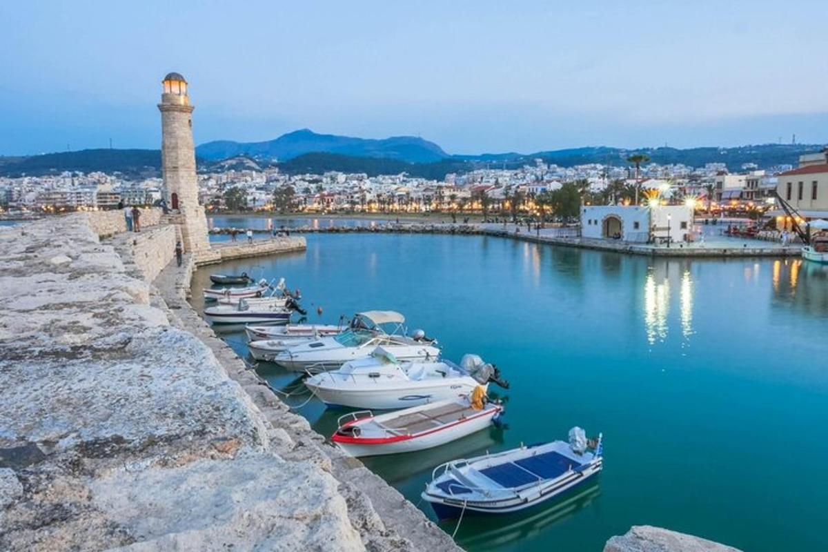 a group of boats in a harbor with a lighthouse