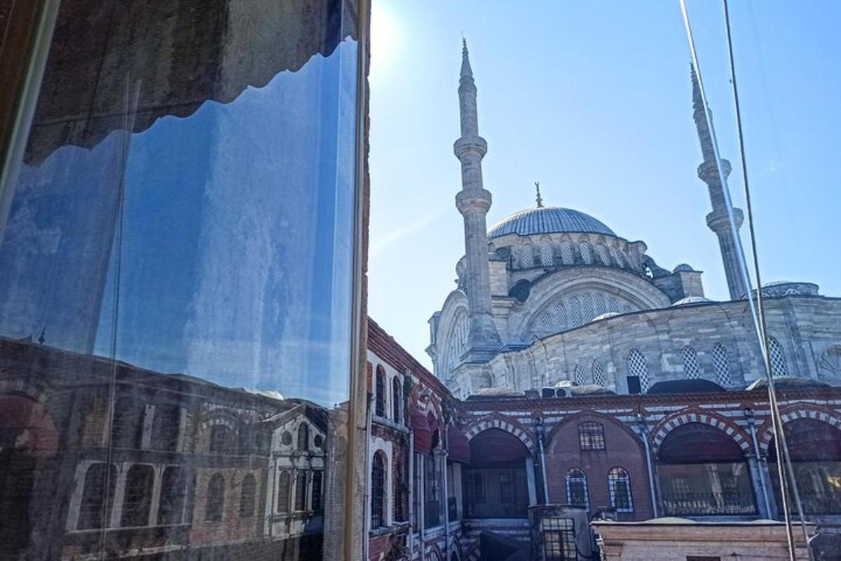 a building with a mosque with a minaret in the background