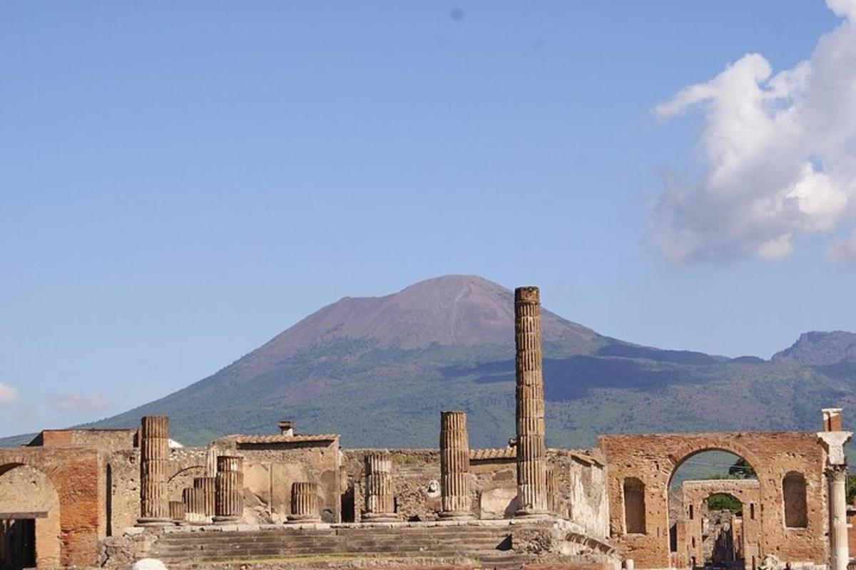 an ancient building with a mountain in the background