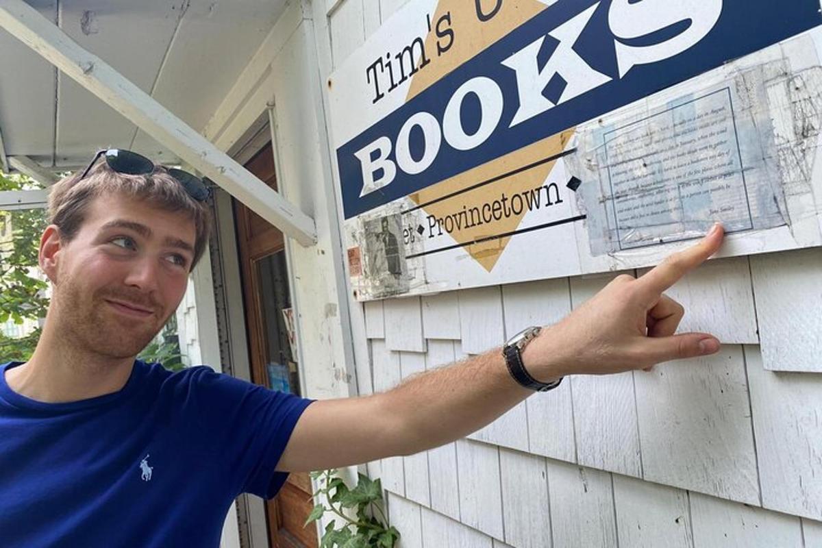a man standing in front of a shop with his hand gesture