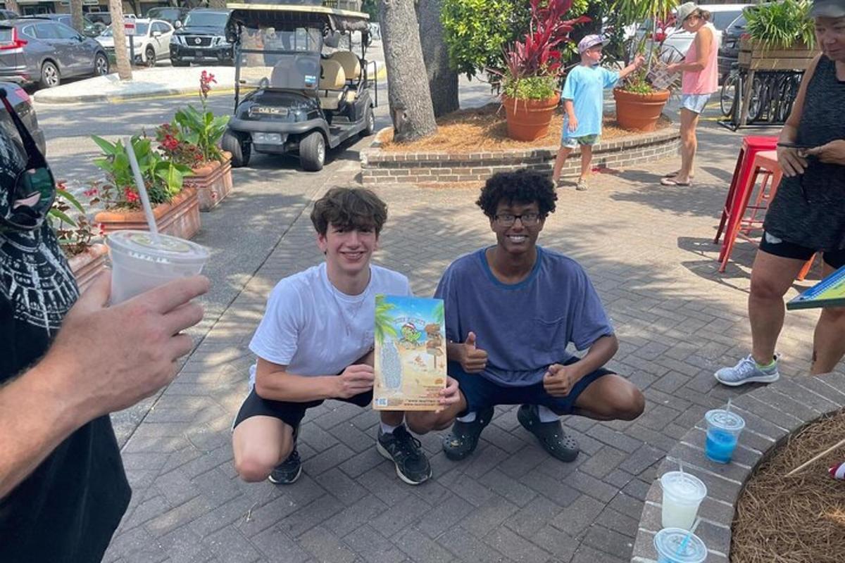 two young men sitting on the ground holding a gift