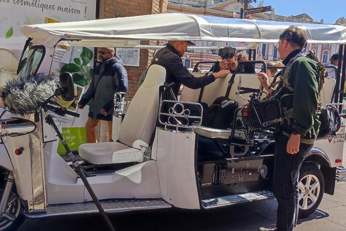 a man standing in the back of a golf cart