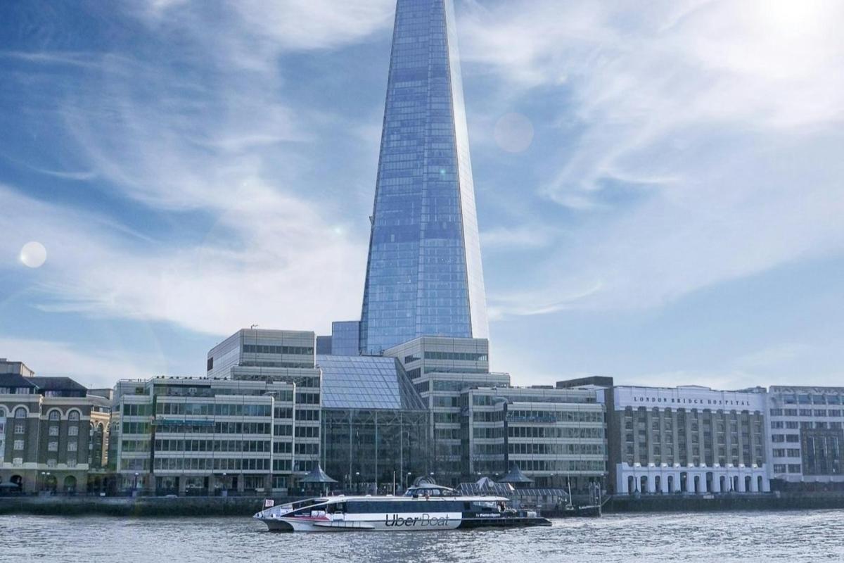 a boat in the water in front of a tall building