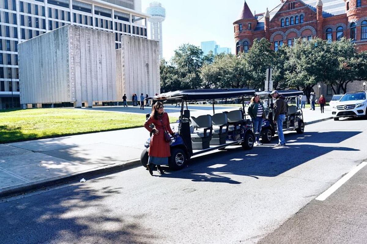 a woman walking down a street with a horse drawn carriage