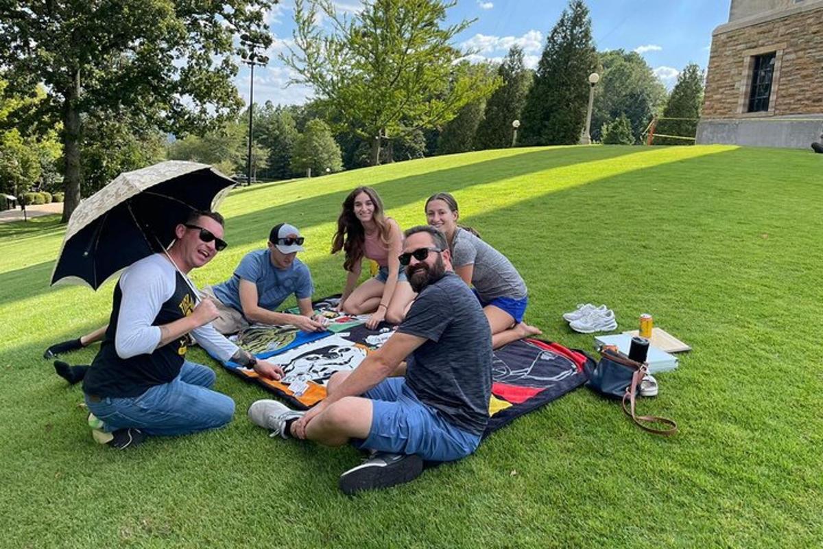 a group of people sitting on the grass