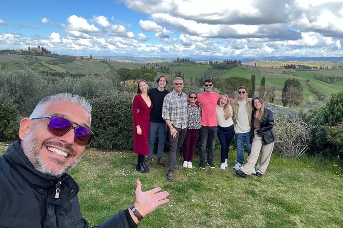 a group of people posing for a picture on a hill