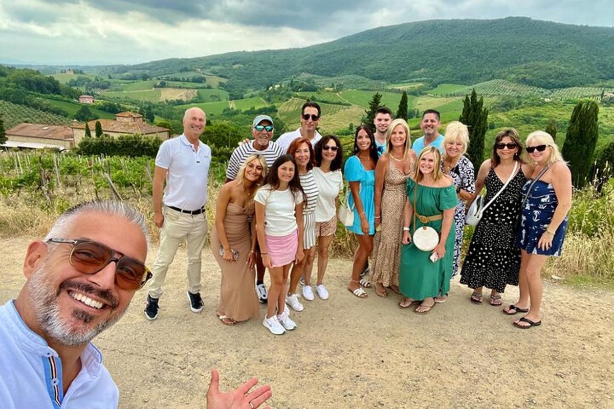 a group of people posing for a picture on a hill