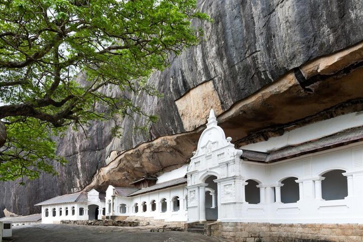 a white building in front of a mountain