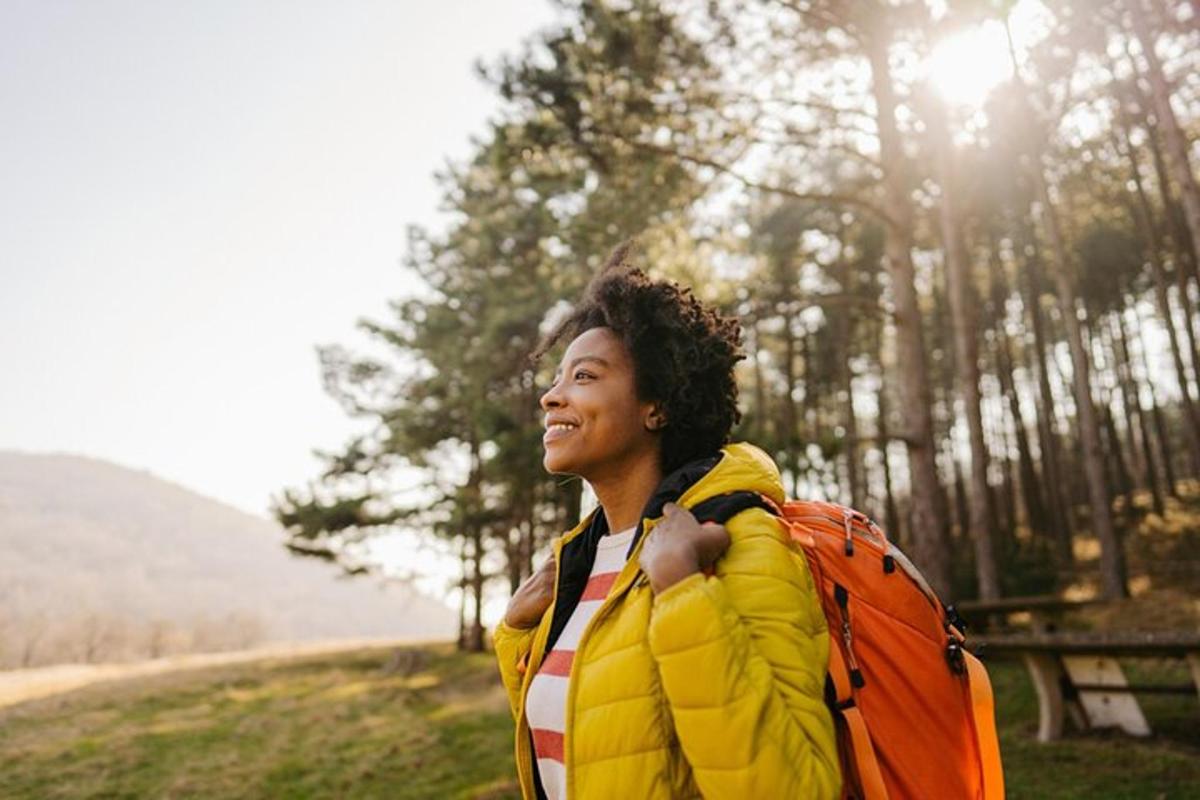 a man in a yellow jacket with a backpack