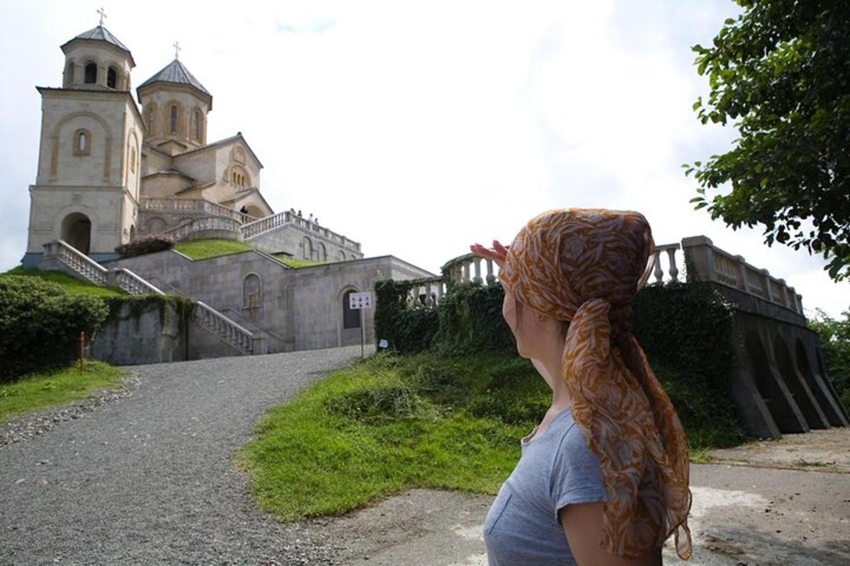 a woman is standing in front of an old building