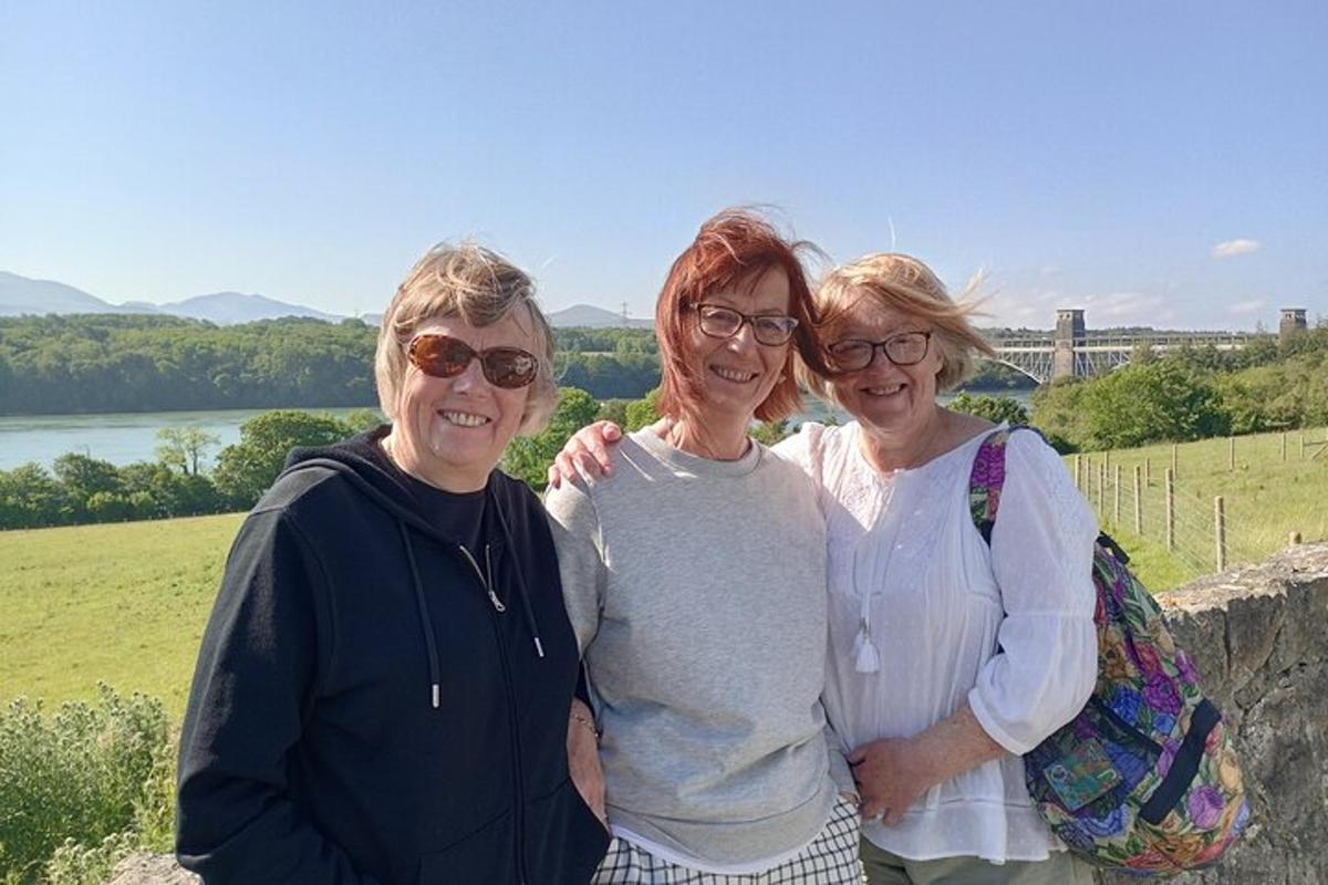 three women are posing for a picture on a wall