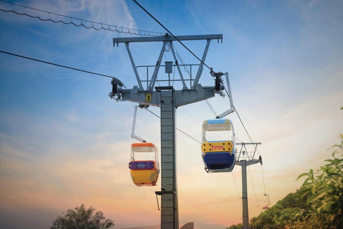 two gondolas on a ski lift at sunset