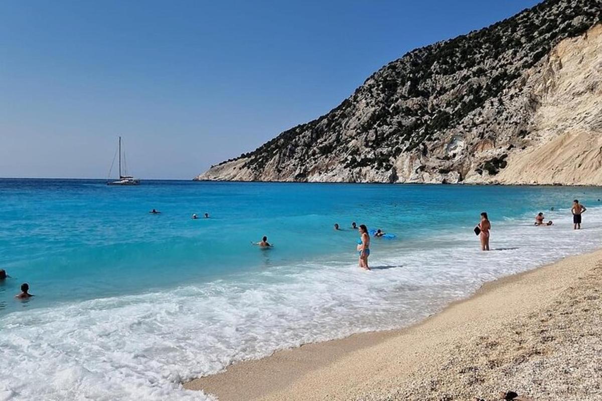 a group of people in the water at a beach