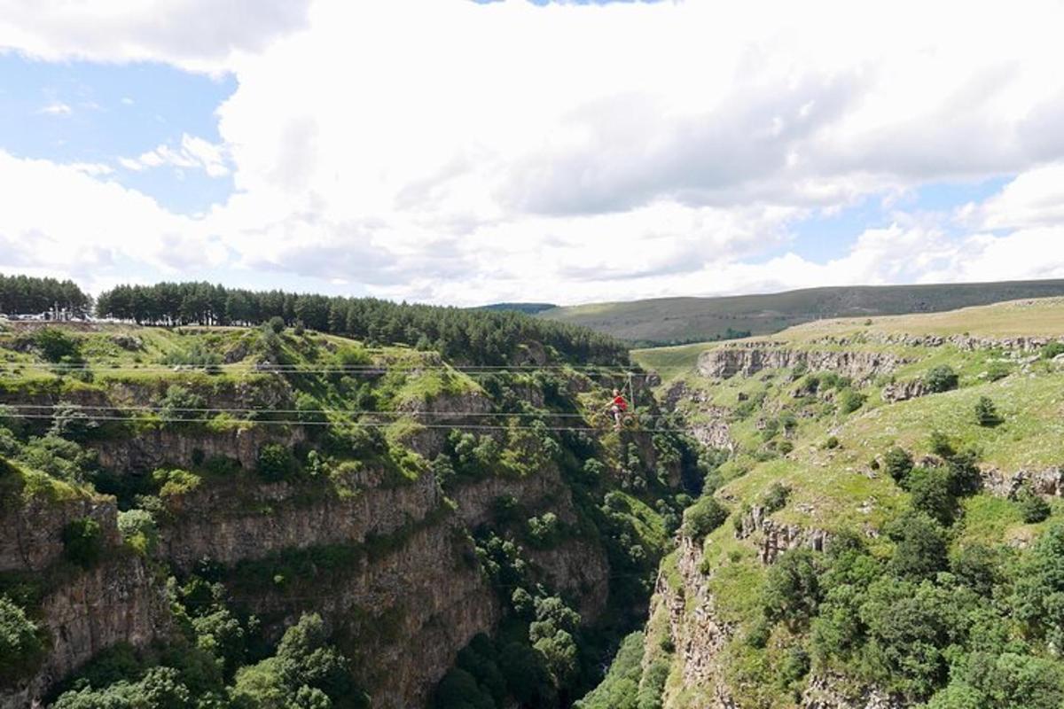 a zip line over a canyon in the mountains