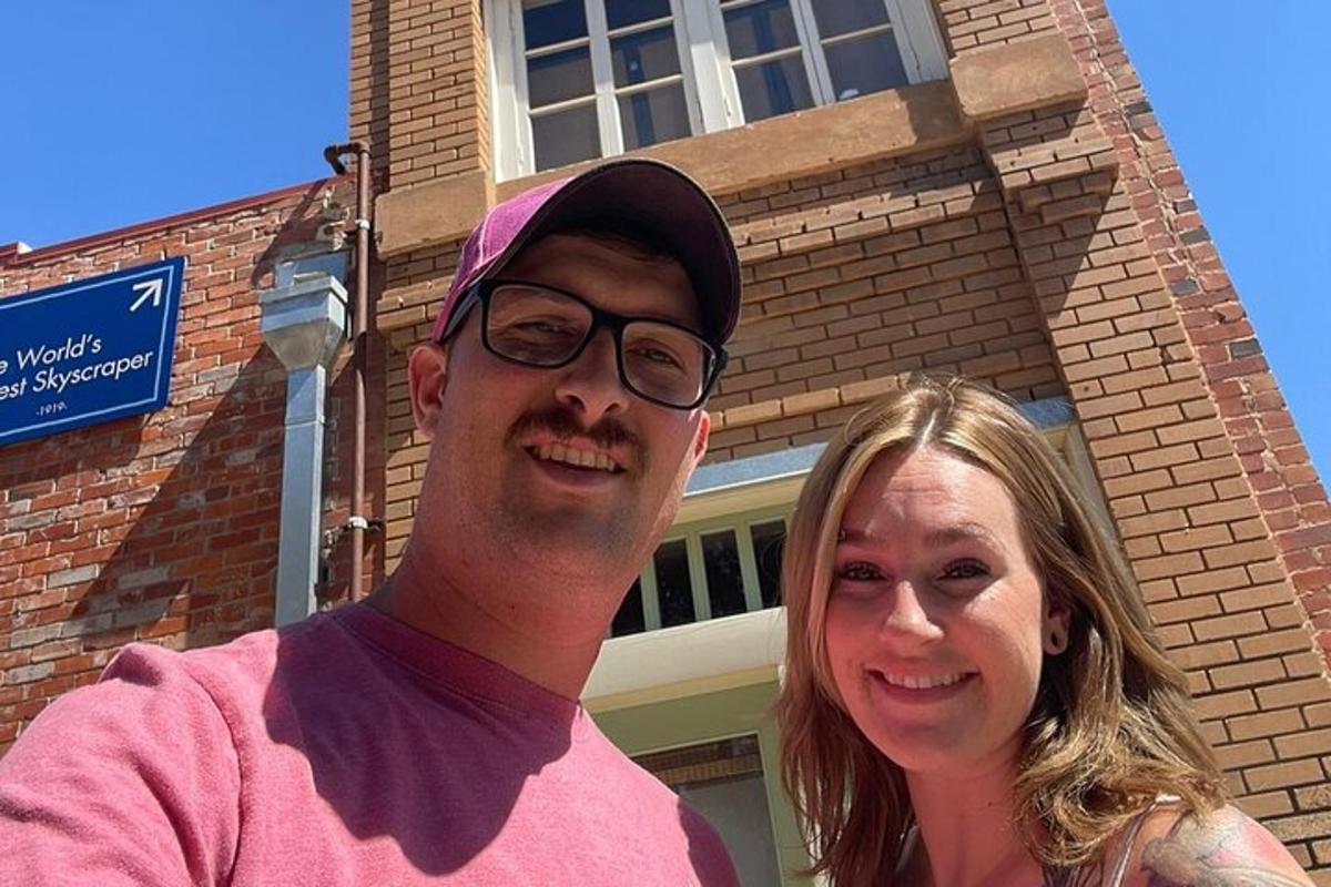 a man and a woman standing in front of a building