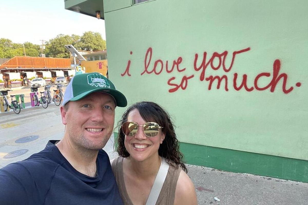 a man and a woman standing in front of a sign